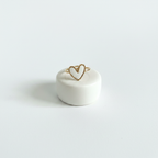 Bague cœur blanc et doré sur fond blanc