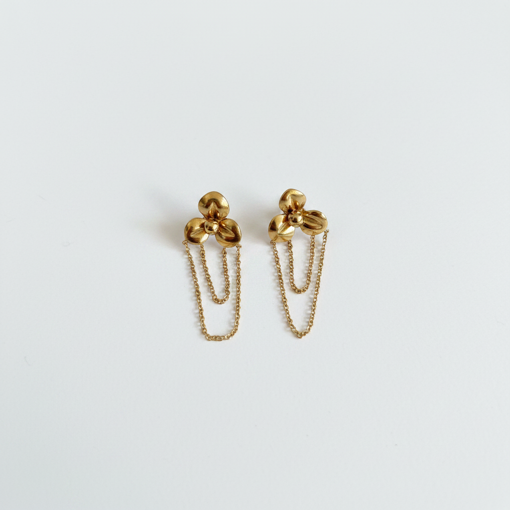 Boucles d'oreilles dorées sur fond blanc